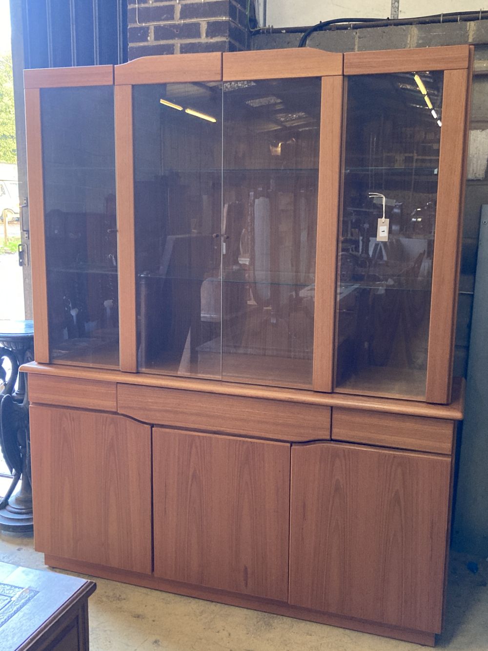 Skovby, Denmark, a teak cabinet fitted plate glass doors over three drawers and three cupboards, width 165cm, depth 47cm, height 196cm